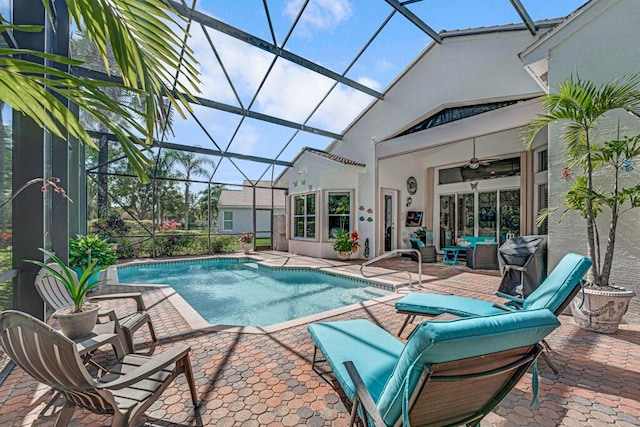 view of pool featuring a lanai, an outdoor hangout area, ceiling fan, and a patio area