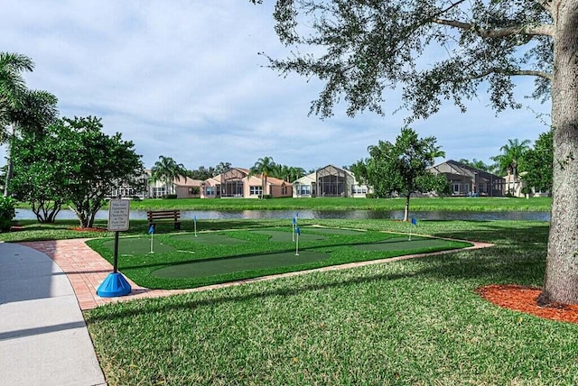 view of home's community with a yard and a water view