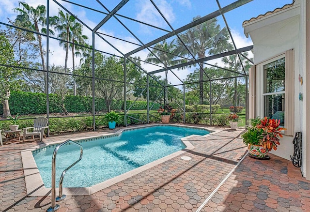 view of pool with a lanai and a patio area