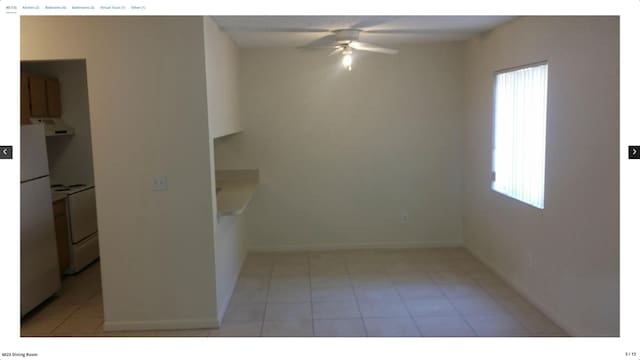 unfurnished room featuring light tile patterned flooring and ceiling fan