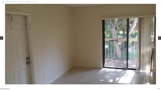 spare room featuring light tile patterned floors