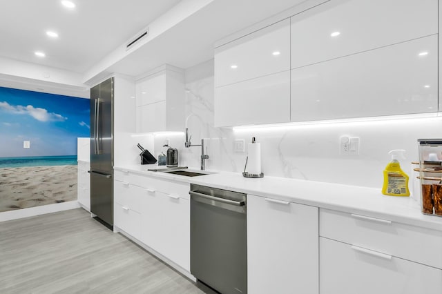 1155 Hillsboro Mile Unit 202, Hillsboro Beach, FL 33062 - kitchen with sink, light hardwood / wood-style flooring, white cabinets, and appliances with stainless steel finishes