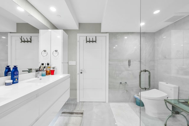 1155 Hillsboro Mile Unit 202, Hillsboro Beach, FL 33062 - bathroom with vanity, an enclosed shower, tile walls, and toilet
