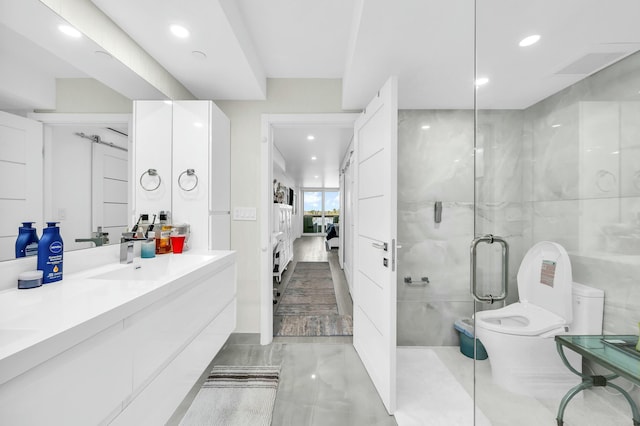 1155 Hillsboro Mile Unit 202, Hillsboro Beach, FL 33062 - bathroom with vanity, tile walls, an enclosed shower, and toilet