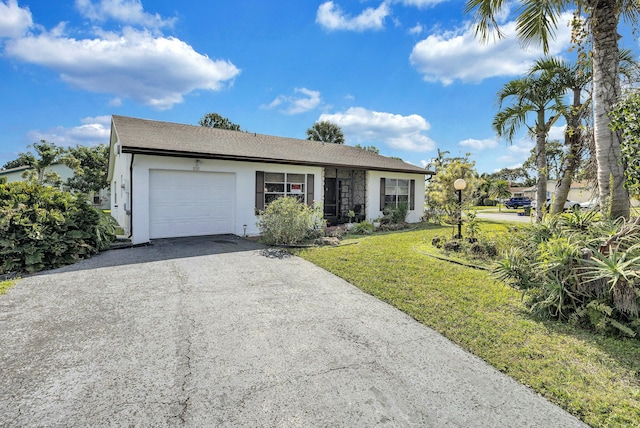 view of front of property featuring a garage and a front lawn