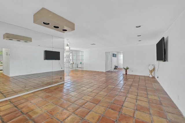 unfurnished living room featuring tile patterned flooring