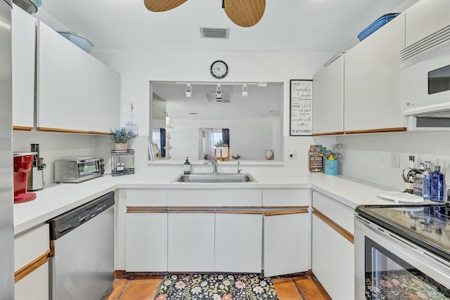 kitchen with sink, white cabinets, and appliances with stainless steel finishes