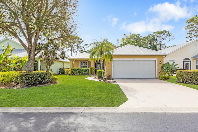 ranch-style house with a garage, metal roof, a front lawn, and stucco siding