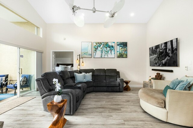 living room with a high ceiling and light wood-type flooring