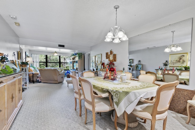 carpeted dining room featuring an inviting chandelier and a textured ceiling