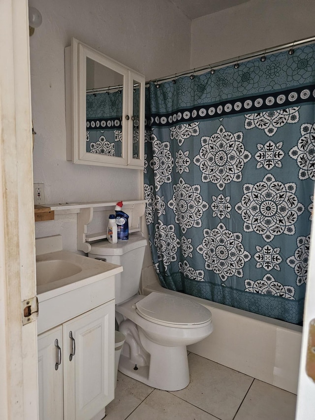 full bathroom with vanity, toilet, tile patterned flooring, and shower / bath combo