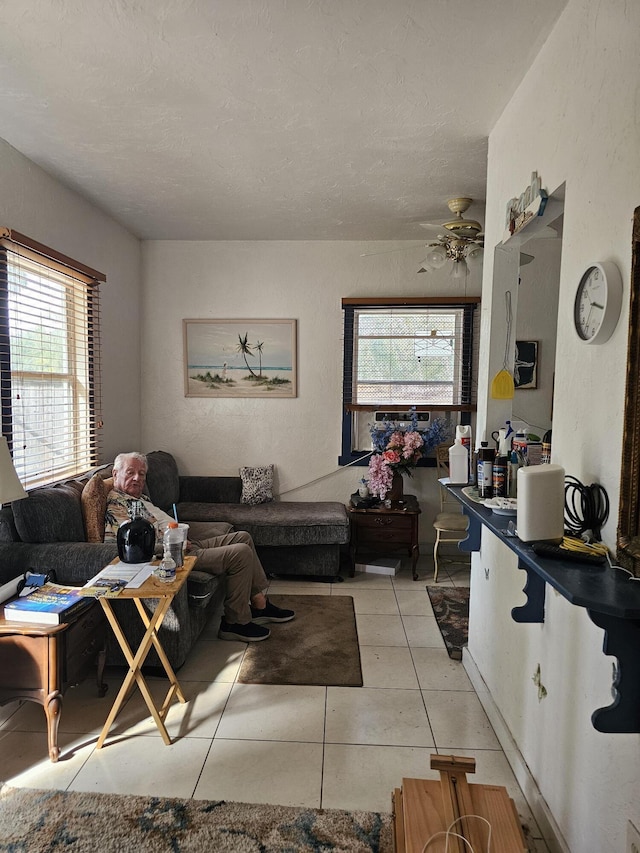 tiled living room featuring ceiling fan