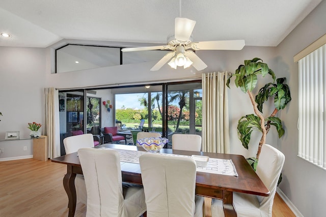 dining area featuring vaulted ceiling, ceiling fan, and light hardwood / wood-style flooring