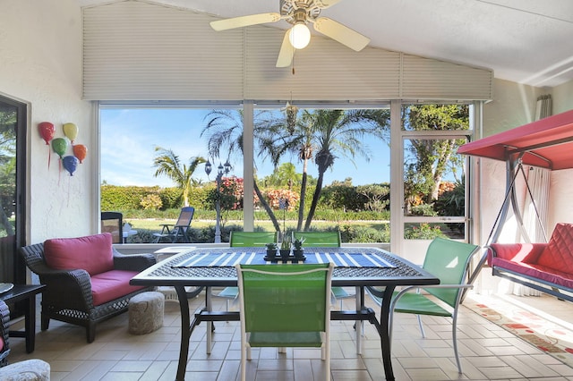 sunroom with lofted ceiling and ceiling fan