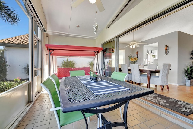 sunroom / solarium featuring lofted ceiling and ceiling fan