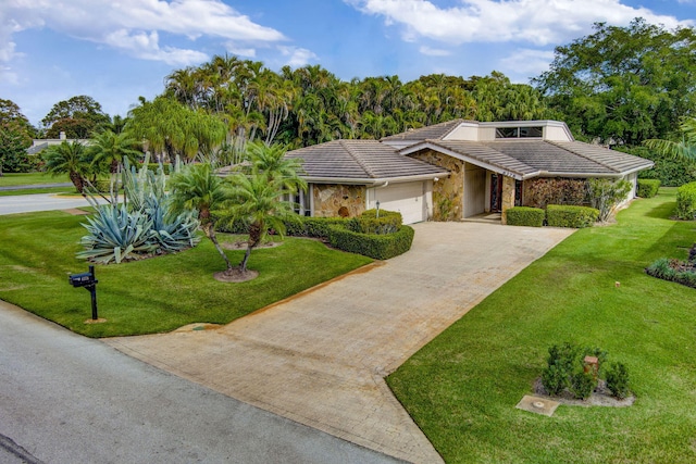 view of front of home featuring a garage and a front yard