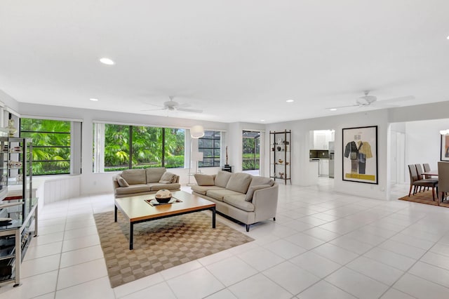 living room with ceiling fan and light tile patterned flooring