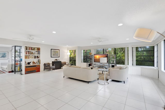 living room with light tile patterned floors, plenty of natural light, and ceiling fan