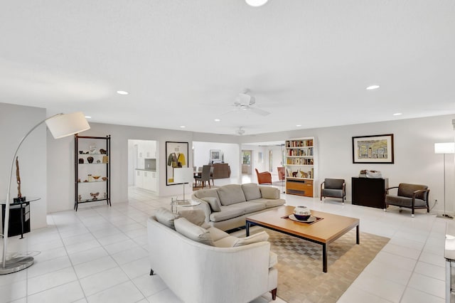 living room with light tile patterned floors and ceiling fan