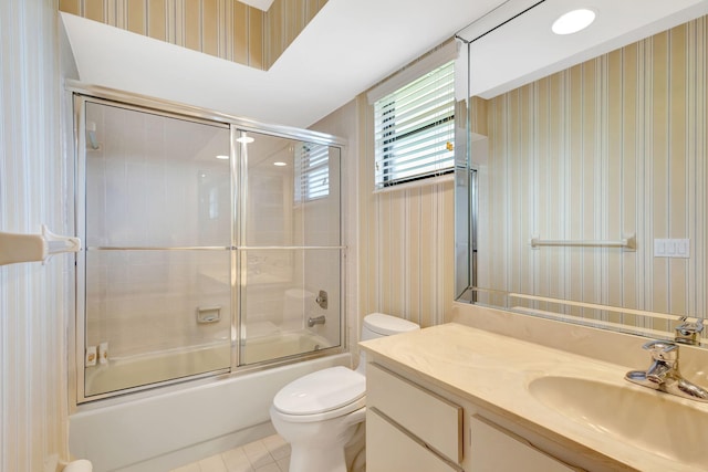 full bathroom featuring tile patterned flooring, vanity, bath / shower combo with glass door, and toilet