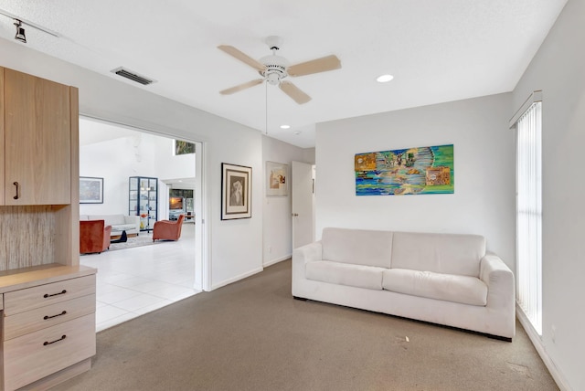 carpeted living room featuring ceiling fan