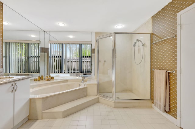 bathroom featuring tile patterned floors, vanity, and separate shower and tub