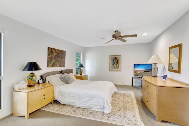 bedroom with ceiling fan and light colored carpet