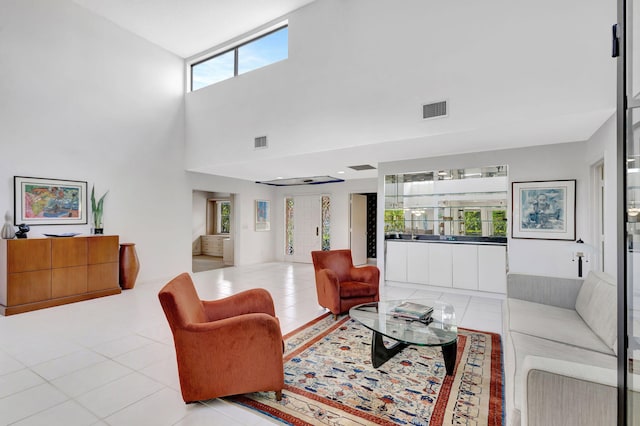 tiled living room featuring a high ceiling