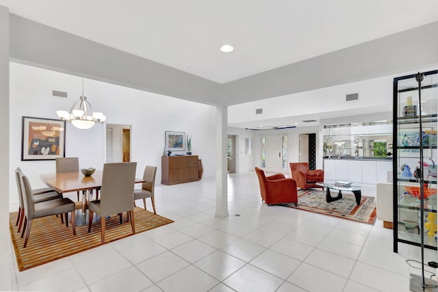 dining room with light tile patterned floors and a notable chandelier