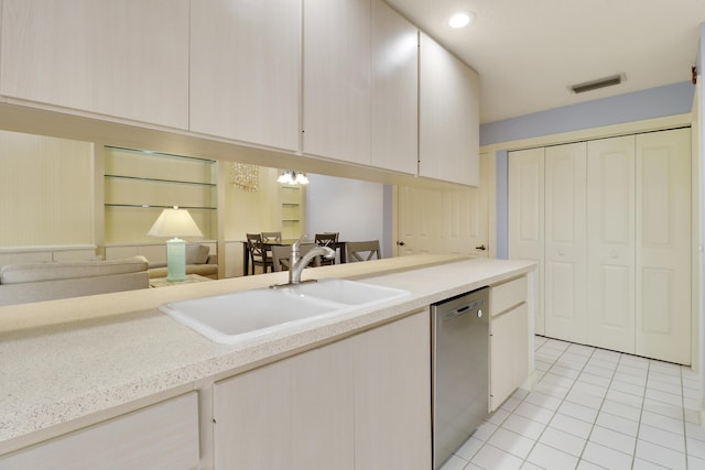 kitchen featuring sink, stainless steel dishwasher, and light tile patterned floors