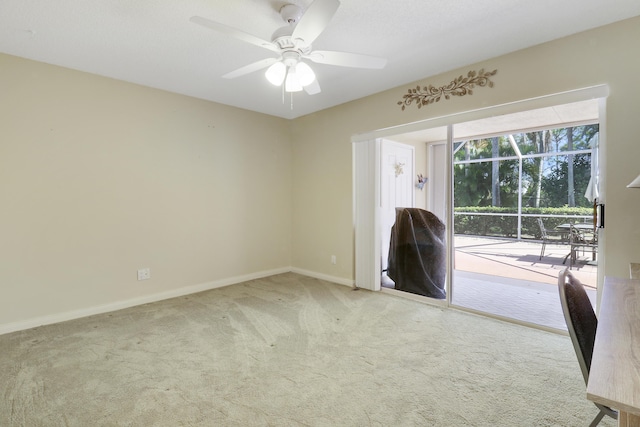 carpeted spare room with ceiling fan