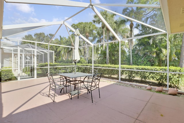 view of patio / terrace featuring glass enclosure