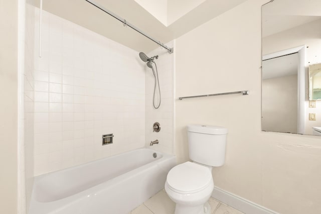 bathroom with tiled shower / bath combo and toilet