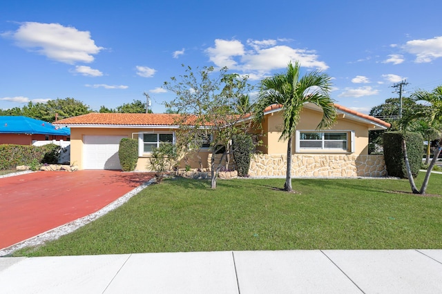 single story home with a garage and a front lawn