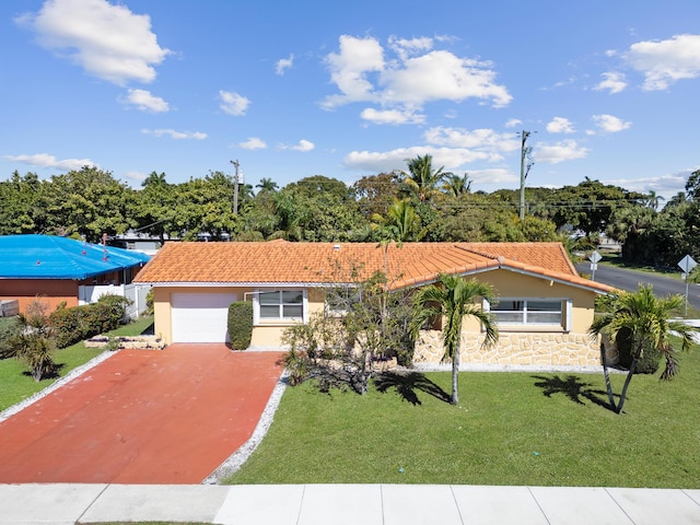 view of front of house with a garage and a front lawn