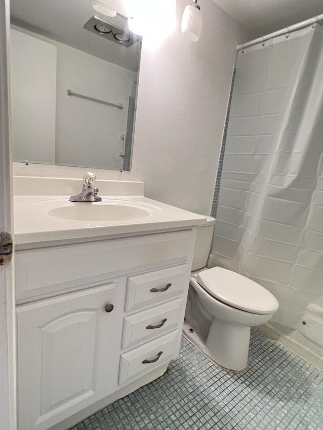 bathroom featuring vanity, a shower with curtain, tile patterned floors, and toilet