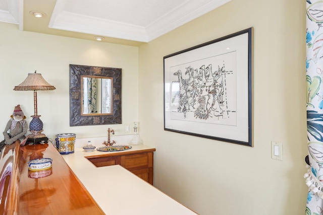 bathroom with ornamental molding and vanity