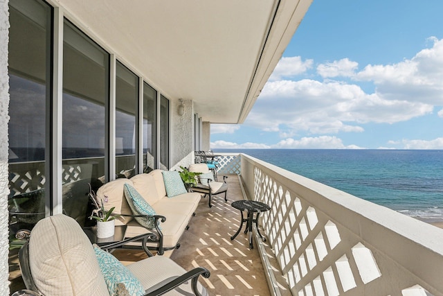 balcony featuring a water view and an outdoor hangout area