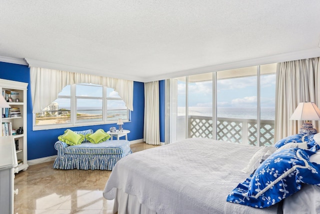 bedroom featuring crown molding, a water view, a textured ceiling, and access to outside