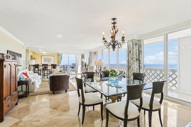 dining room featuring expansive windows, a notable chandelier, crown molding, a water view, and a textured ceiling