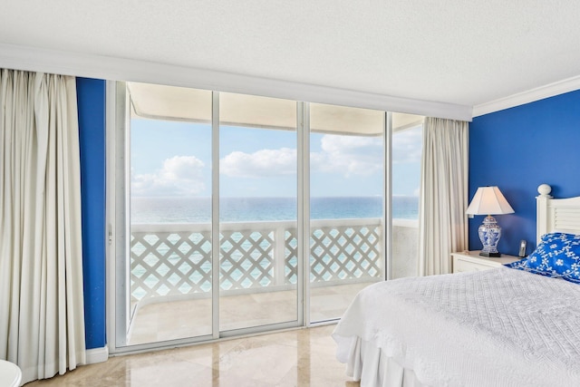 bedroom with multiple windows, access to outside, expansive windows, and a water view