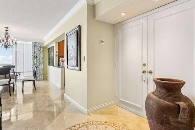 interior space featuring a notable chandelier, crown molding, and a textured ceiling