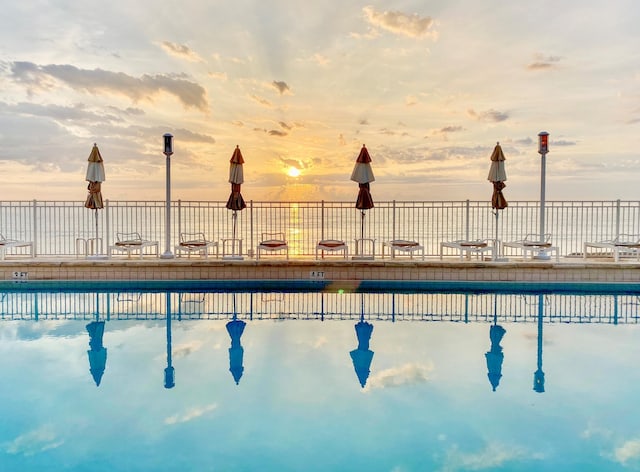 view of pool at dusk