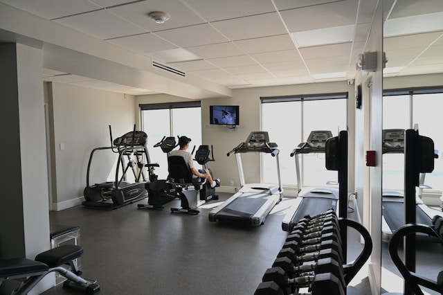 exercise room with a wealth of natural light and a paneled ceiling