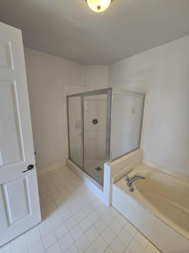 full bath with a stall shower, a garden tub, and tile patterned floors