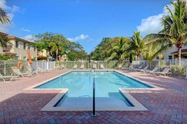 pool featuring a patio area and fence