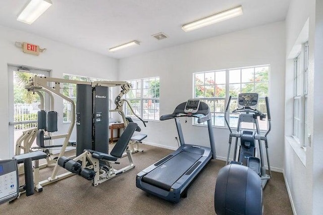 exercise room featuring visible vents and baseboards