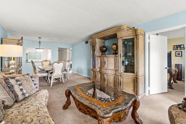 living room with a textured ceiling and carpet flooring