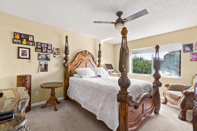 carpeted bedroom with ceiling fan and a textured ceiling