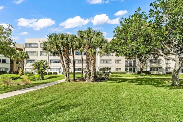 view of property's community with a lawn